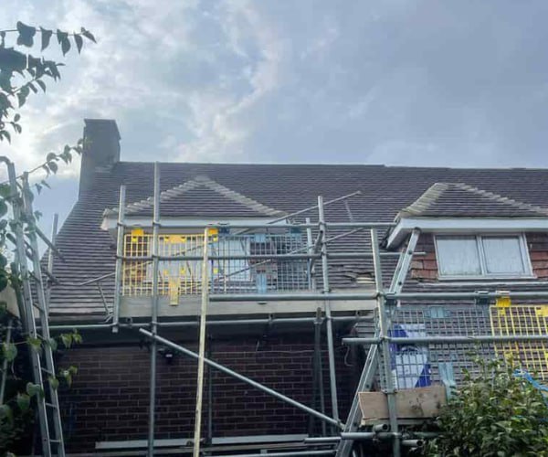 This is a photo of a roof with two dormers that is having some damaged tiles replaced. Works carried out by CNB Roofing Pontefract