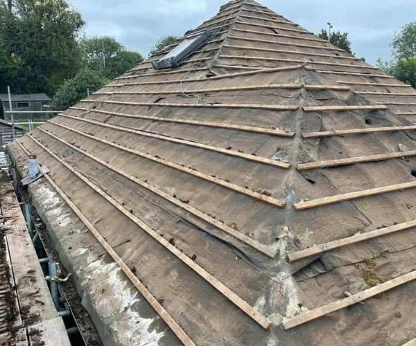 This is a photo of a hip roof that has been stripped back to the battens, and is awaiting a new roof covering to be installed. Works carried out by CNB Roofing Pontefract